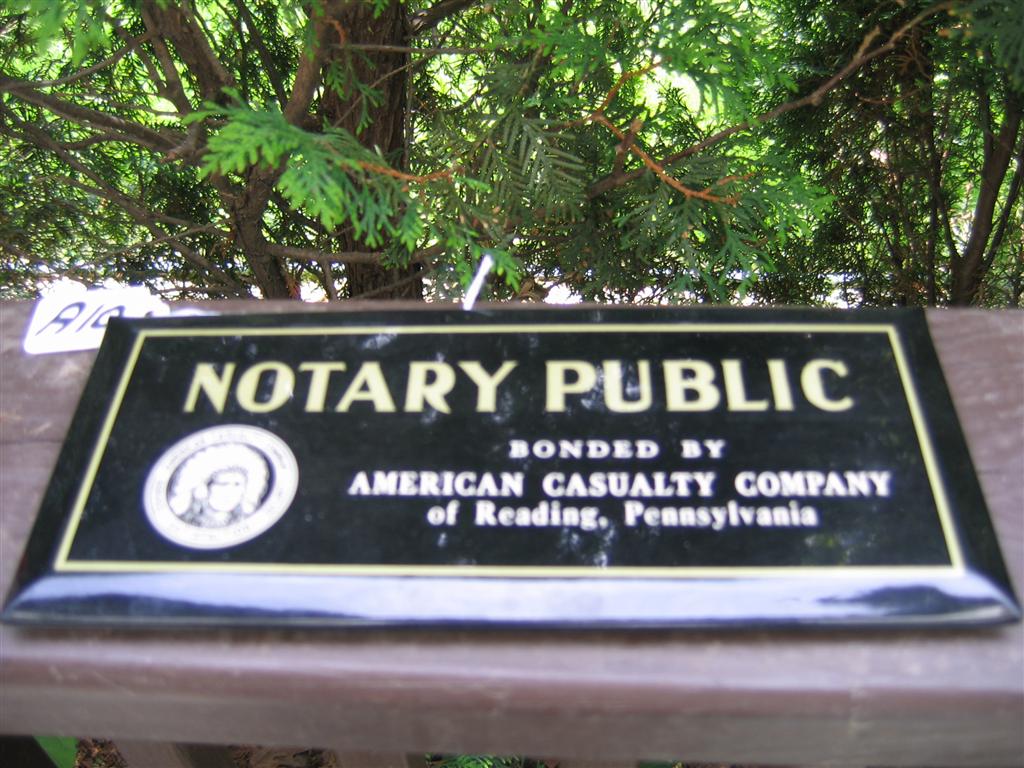 Sign. Black background on metal. Notary Public.
