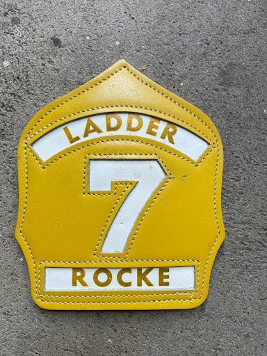 #229 7 Ladder Rocke Fire Helmet Shield. Yellow. 6 inches long.