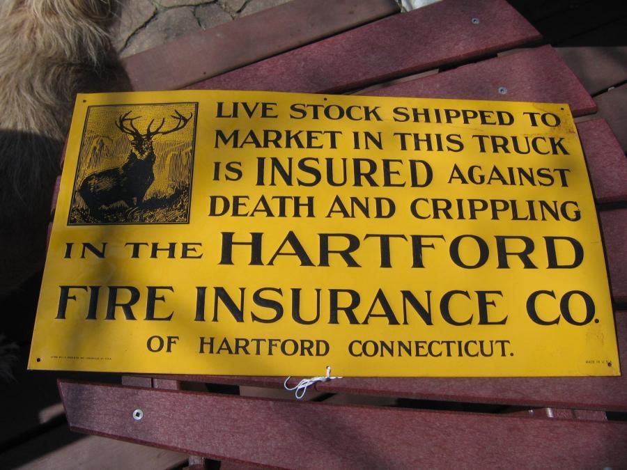 #019 Hartford Livestock Sign. Bright yellow with black lettering. Metal. Given to the Hartford farming Policy holders.