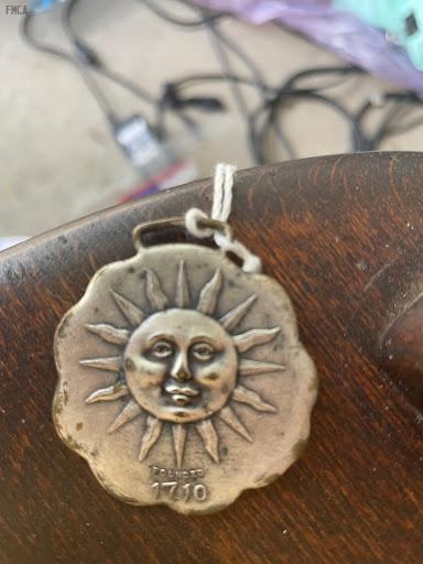 #061 Sun Insurance Watch Fob with Sun Motif. Says Sun Insurance Office on the back. 1 ½ inches. Circular.