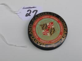 #027 Maryland Casualty Company.  Advertising Paperweight. 2  ½ inches Round. Both Sides have the same Advertising.